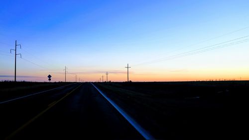 Road against clear sky during sunset