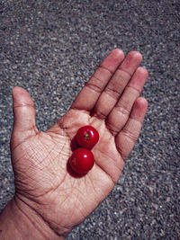 Close-up of hand holding strawberry