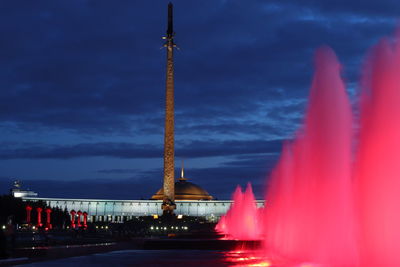 Illuminated fountain against sky at night