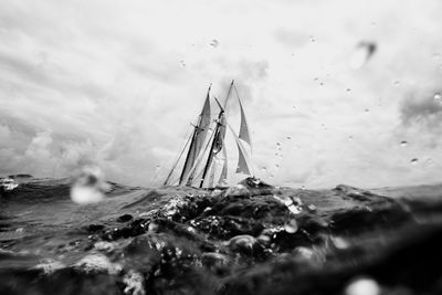 Boat sailing in sea against sky