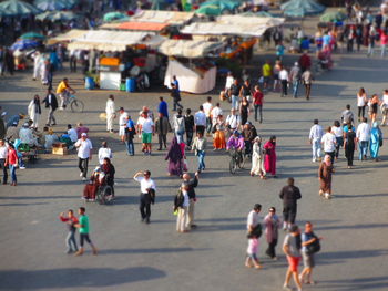 Tilt shift image of people at street market