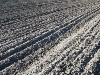 Full frame shot of tire tracks on snowy field