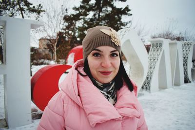 Portrait of smiling woman in snow