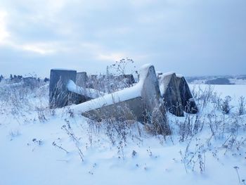 Snow covered field against sky
