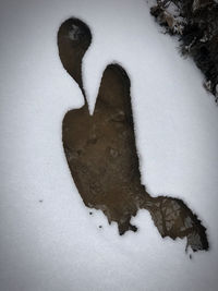 High angle view of footprints on snow covered field