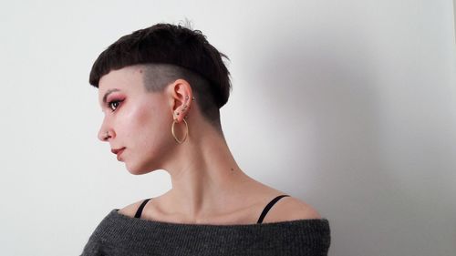 Portrait of beautiful young woman against white background