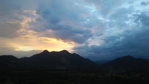 Scenic view of silhouette mountains against sky during sunset