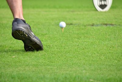 Low section of man playing golf course