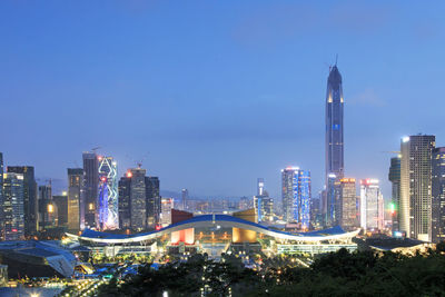 Ping an finance centre with illuminated cityscape against sky at dusk