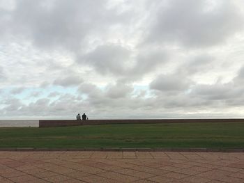 Scenic view of landscape against cloudy sky