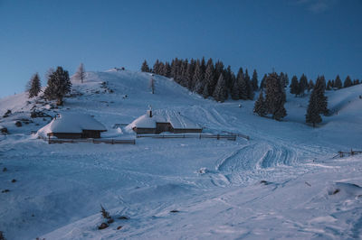 Snow covered field against sky