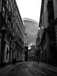 Street amidst buildings against sky in city