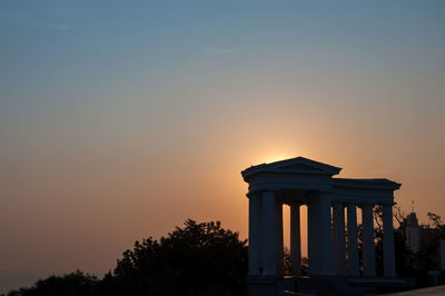 Low angle view of building against sky during sunset