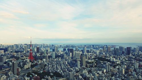 Cityscape against cloudy sky