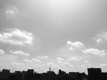 Low angle view of buildings against cloudy sky