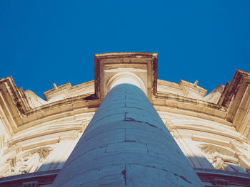 Low angle view of historical building against clear blue sky