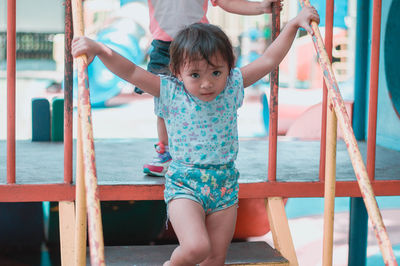 Full length portrait of girl on railing