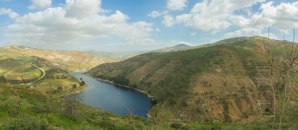 Scenic view of lake and mountains against sky