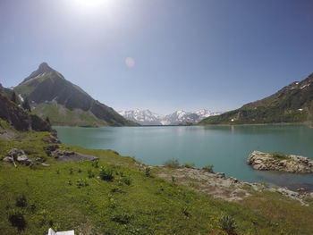 Scenic view of lake and mountains against sky