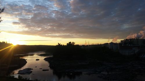 Scenic view of silhouette city against sky during sunset