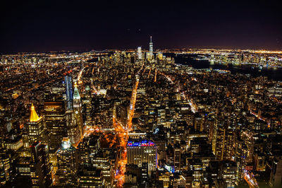 Aerial view of city lit up at night