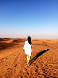 Rear view of woman standing on landscape