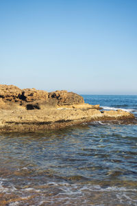 Scenic view of sea against clear blue sky