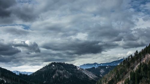Scenic view of mountains against cloudy sky