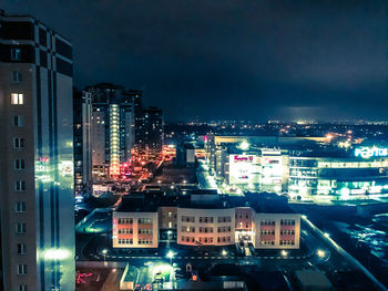 High angle view of illuminated buildings in city at night