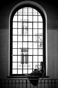 Woman looking through window