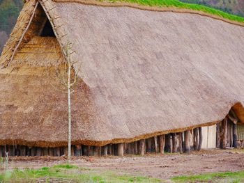 Old barn on field by building