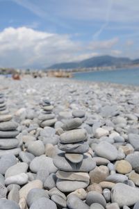 Stack of stones on beach against sky