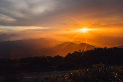 Scenic view of silhouette mountains against sky at sunset