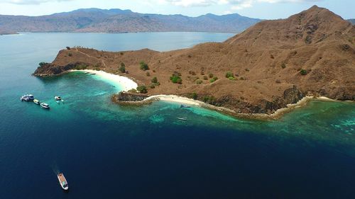 High angle view of boats sailing in sea by island