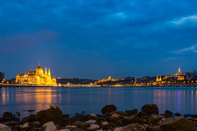 Illuminated buildings against blue sky