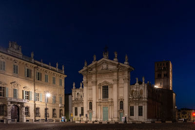 Low angle view of illuminated buildings at night