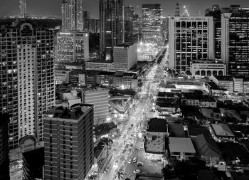 High angle view of illuminated buildings in city at night