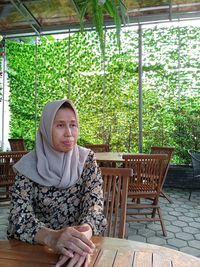 Portrait of young woman sitting at outdoor cafe