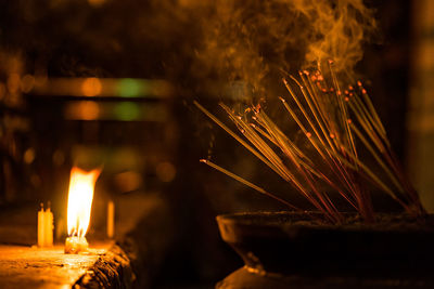 Close-up of lit candles in temple