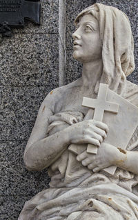 Close-up of statue against stone wall