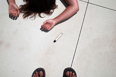 Low section of woman standing on tiled floor