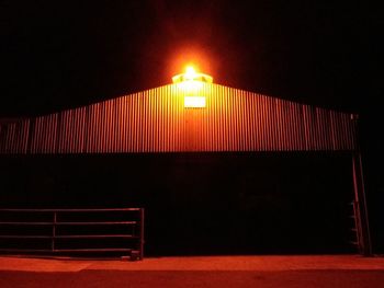 Illuminated lamp against sky at night
