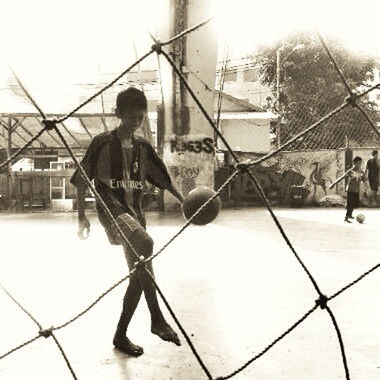 lifestyles, leisure activity, full length, childhood, men, chainlink fence, boys, casual clothing, fence, playing, enjoyment, girls, standing, togetherness, protection, fun, sky