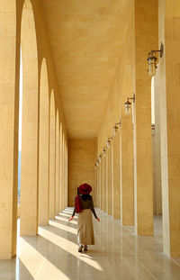Rear view of woman on corridor of building
