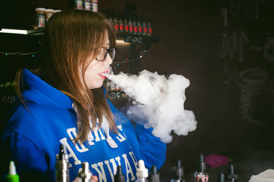 Young woman exhaling smoke