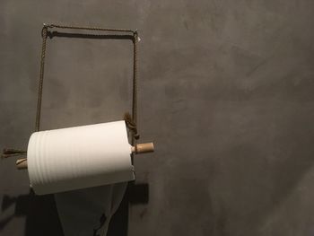 Close-up of toilet paper hanging against wall