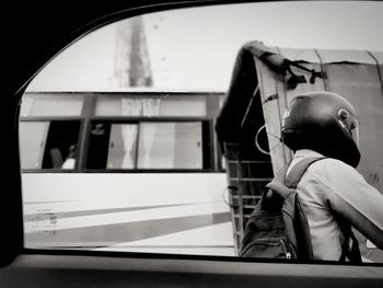 Full length of boy in car window