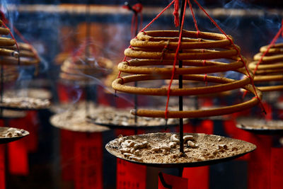 Close-up of spiral incense burning at temple