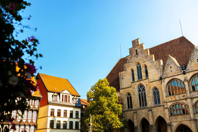 Low angle view of building against clear blue sky