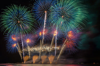 Low angle view of firework display at night